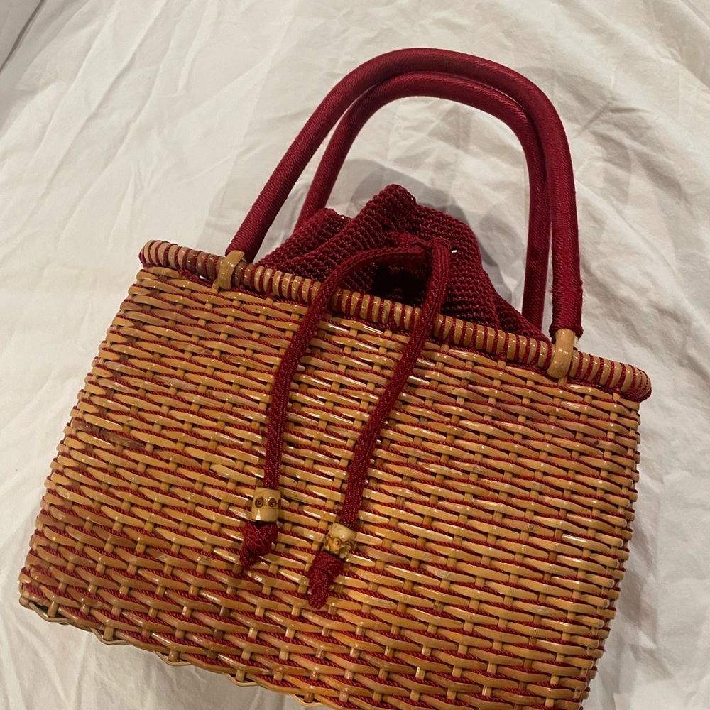 Rattan purse with red threading/trim and liner.